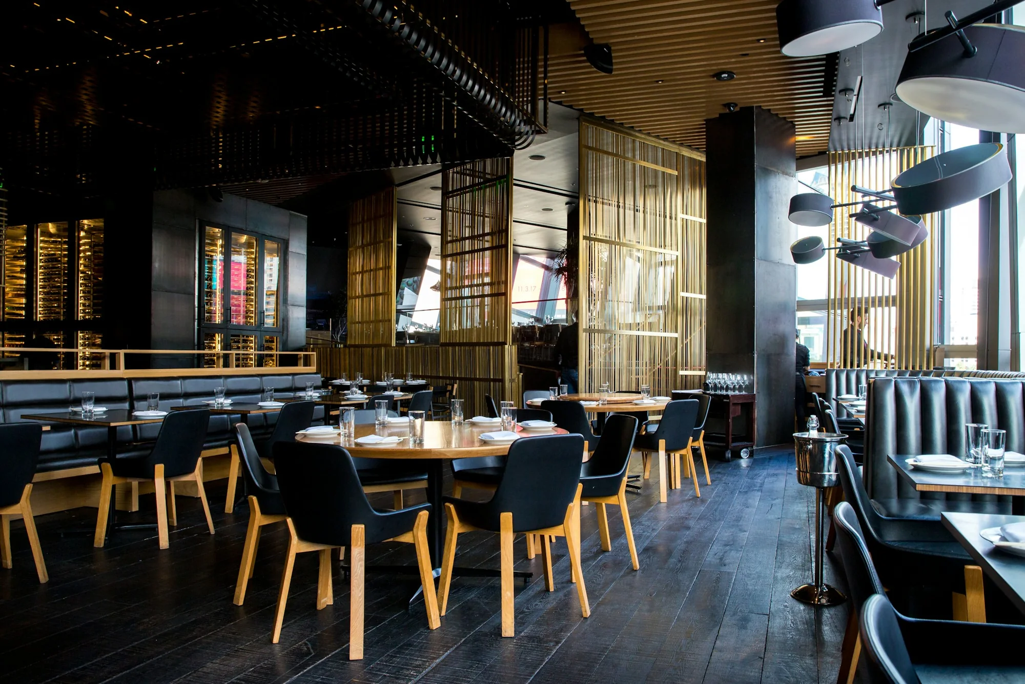 A sunlit restaurant with carefully set tables, ready for the evening service.